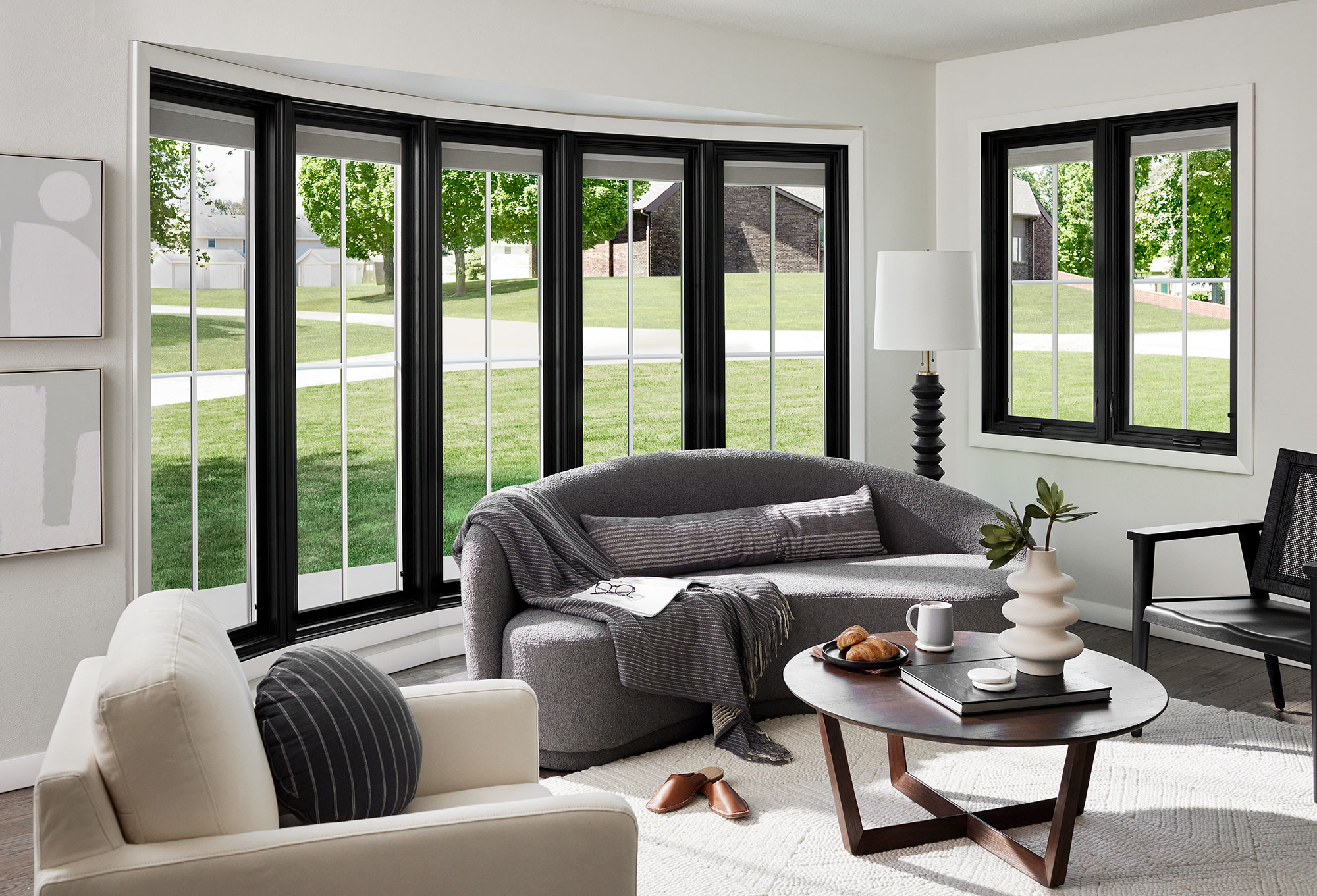 Black bow window with grilles in modern living room
