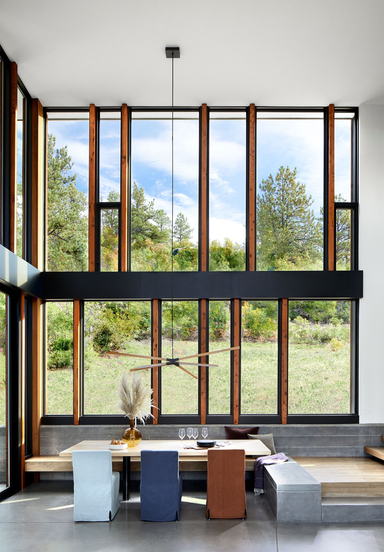 Floor-to-ceiling picture windows in modern dining room