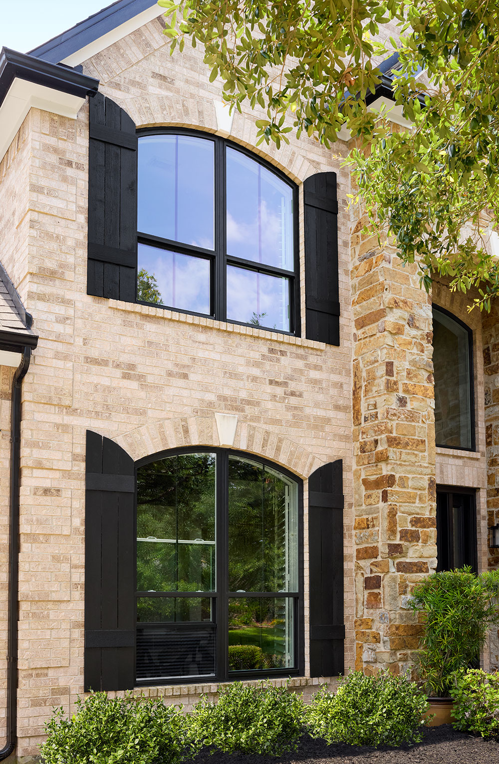 Arched single-hung windows on brick facade