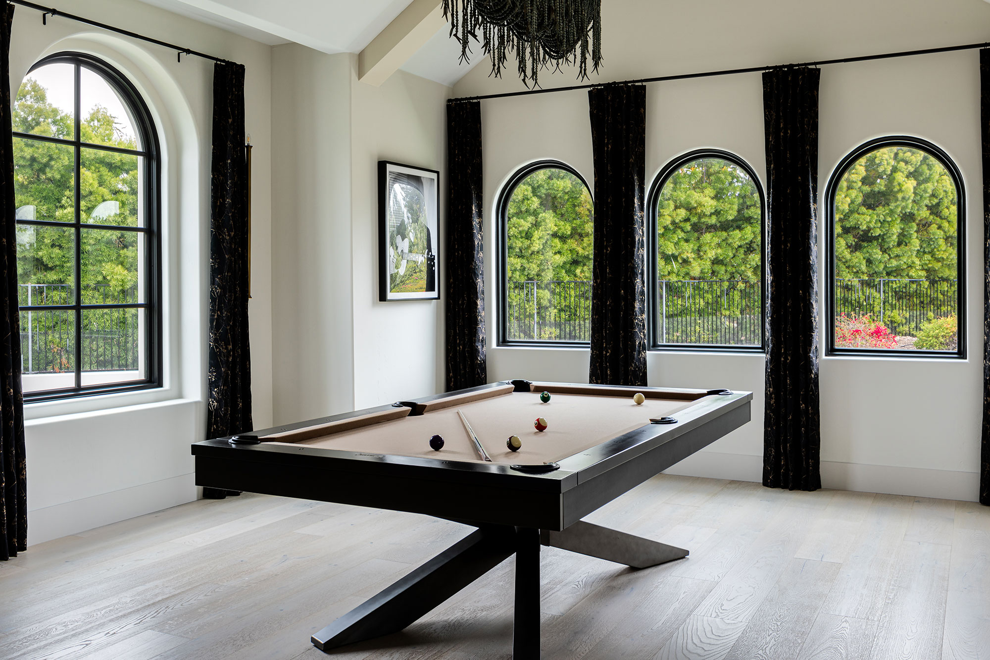 Multiple arched windows in billiard room