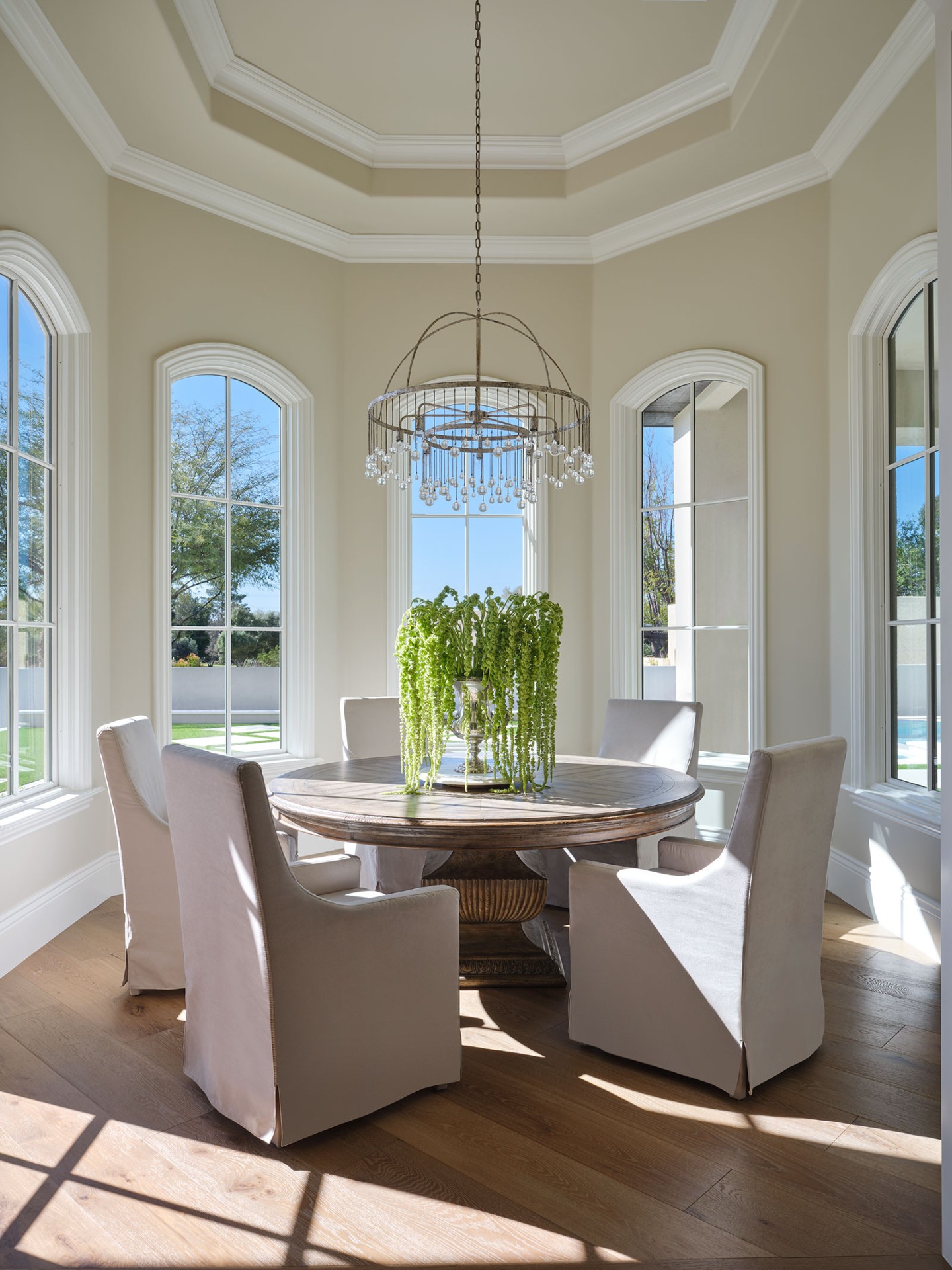 Arched windows in elegant dining nook with chandelier